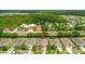 Beautiful aerial view of a home located near trees, road and a community fire station at 1481 Areca Palm Dr, Port Orange, FL 32128