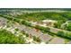 Lovely aerial view of house in a well-maintained community near a road, and community fire station at 1481 Areca Palm Dr, Port Orange, FL 32128