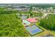 Aerial view of community clubhouse, pools, tennis courts, and surrounding lakes at 1481 Areca Palm Dr, Port Orange, FL 32128