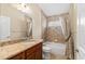 Bathroom featuring granite counters, a large mirror, a bathtub, and a shower with a curtain at 1481 Areca Palm Dr, Port Orange, FL 32128