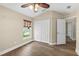 Bedroom features wood-look floors, a ceiling fan, a window with blinds, and a double door closet at 1481 Areca Palm Dr, Port Orange, FL 32128