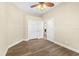 Bedroom features wood-look floors, a ceiling fan, a double door closet, and a glass pane door at 1481 Areca Palm Dr, Port Orange, FL 32128