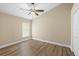 Bedroom featuring wood-look floors, a ceiling fan, and a window with a blind at 1481 Areca Palm Dr, Port Orange, FL 32128