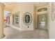 Charming front porch with columns, decorative windows, and tiled flooring at 1481 Areca Palm Dr, Port Orange, FL 32128