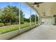 Screened lanai with ceiling fans overlooking lush backyard with tropical landscaping and blue sky at 1481 Areca Palm Dr, Port Orange, FL 32128