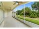 Spacious screened lanai with ceiling fans, providing scenic views of the lush backyard at 1481 Areca Palm Dr, Port Orange, FL 32128