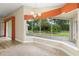 Bright sunroom with tile flooring, large windows offering views of the fenced backyard, and a decorative chandelier at 1481 Areca Palm Dr, Port Orange, FL 32128