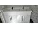 Bathroom vanity featuring double sinks with modern black faucets and hardware at 1568 Pendleton St, Deltona, FL 32725