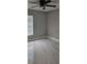 Simple bedroom features light walls, tile flooring, and ceiling fan at 1568 Pendleton St, Deltona, FL 32725