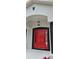 Stylish front entrance with a red door and black decorative lighting fixture above at 1568 Pendleton St, Deltona, FL 32725