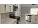 Bright kitchen featuring stainless steel appliances, modern white cabinets and quartz countertops at 1568 Pendleton St, Deltona, FL 32725