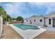 A backyard showcases an in-ground pool, landscaping, shed, and exterior of the home at 1590 Urbana Ave, Deltona, FL 32725
