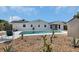 Spacious backyard features a large in-ground pool with desert landscaping, and a shed at 1590 Urbana Ave, Deltona, FL 32725
