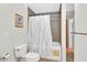 The full bathroom features a shower with tub and neutral tile at 1590 Urbana Ave, Deltona, FL 32725