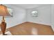 A minimalist bedroom with laminate floors and bright natural light from the window at 1590 Urbana Ave, Deltona, FL 32725