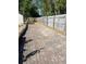 Paver driveway with side privacy fence leading to a detached structure at 1590 Urbana Ave, Deltona, FL 32725