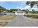 Single-story home featuring a two-car garage and a long driveway at 1590 Urbana Ave, Deltona, FL 32725