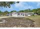 Inviting home exterior with well-maintained lawn, complementing the home's facade and enhancing its curb appeal at 1590 Urbana Ave, Deltona, FL 32725