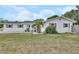 Charming single-story home with a well-maintained lawn, arched entrance, and colorful flower beds in the front yard at 1590 Urbana Ave, Deltona, FL 32725
