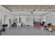 Spacious garage with gray flooring, white walls, and overhead storage, offering ample space for vehicles and storage at 1590 Urbana Ave, Deltona, FL 32725