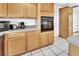 A traditional kitchen with natural wood cabinets and a built-in oven at 1590 Urbana Ave, Deltona, FL 32725