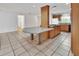Open concept kitchen with a large center island and tile flooring at 1590 Urbana Ave, Deltona, FL 32725