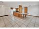 Open concept kitchen and living space with tile flooring and recessed lighting at 1590 Urbana Ave, Deltona, FL 32725