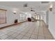 Spacious living room with tile flooring, recessed lighting, ceiling fans, and large windows providing natural light at 1590 Urbana Ave, Deltona, FL 32725