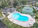 Aerial view of an outdoor kidney-shaped community pool, tennis court and clubhouse at 16 Big Buck Trl, Ormond Beach, FL 32174