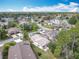 Aerial view of the neighborhood with mature trees and a pond at 16 Big Buck Trl, Ormond Beach, FL 32174