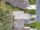 Overhead shot of rooftops and lawns with mature trees; vehicles parked in driveways at 16 Big Buck Trl, Ormond Beach, FL 32174
