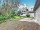 Backyard featuring concrete patio, grass, mature trees and landscaping at 16 Big Buck Trl, Ormond Beach, FL 32174