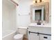 Bright bathroom featuring white vanity with a sliding door and a shower over tub at 16 Big Buck Trl, Ormond Beach, FL 32174