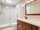 A bathroom featuring tile floors, vanity with mirror, and glass shower enclosure at 16 Big Buck Trl, Ormond Beach, FL 32174