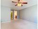 Large bedroom boasts neutral walls and carpet, ceiling fan, and an open bathroom at 16 Big Buck Trl, Ormond Beach, FL 32174