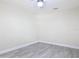 Neutral bedroom featuring wood-look floors, ceiling fan, and simple design at 16 Big Buck Trl, Ormond Beach, FL 32174