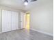 This bedroom has neutral walls, wood-look floors, double closet and a ceiling fan at 16 Big Buck Trl, Ormond Beach, FL 32174