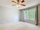 Large bedroom features neutral walls and carpet, a ceiling fan, and a window at 16 Big Buck Trl, Ormond Beach, FL 32174