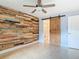 Bedroom with a wooden accent wall, closet, and doorway to another room at 16 Big Buck Trl, Ormond Beach, FL 32174