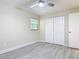 Neutral bedroom featuring wood-look floors, a window, double closet, and a ceiling fan at 16 Big Buck Trl, Ormond Beach, FL 32174