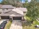 Charming townhome featuring a spacious driveway and attached garage with manicured lawn at 16 Big Buck Trl, Ormond Beach, FL 32174