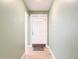 A home's foyer featuring tile flooring, a white front door, and soft green walls at 16 Big Buck Trl, Ormond Beach, FL 32174