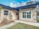 Inviting front entrance with decorative stone accents, manicured landscaping, and pathway at 16 Big Buck Trl, Ormond Beach, FL 32174