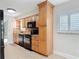 Updated kitchen features wood cabinetry, black appliances, and granite countertops at 16 Big Buck Trl, Ormond Beach, FL 32174