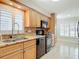 Updated kitchen with granite countertops, stainless steel appliances, and tiled backsplash at 16 Big Buck Trl, Ormond Beach, FL 32174