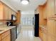 Spacious kitchen with wood cabinets, tile backsplash and stainless steel appliances at 16 Big Buck Trl, Ormond Beach, FL 32174