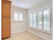 Bright kitchen nook with tiled floor, shuttered windows, and built in cabinet at 16 Big Buck Trl, Ormond Beach, FL 32174