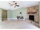 Spacious living room with a stone fireplace, ceiling fan, and tile flooring at 16 Big Buck Trl, Ormond Beach, FL 32174