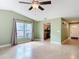 Open-concept living room with neutral paint and tile flooring that flows into the kitchen at 16 Big Buck Trl, Ormond Beach, FL 32174