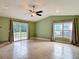 Living room with tile floors, ceiling fan and sliding glass doors at 16 Big Buck Trl, Ormond Beach, FL 32174